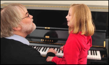 Ockelford and student, Romy, at the piano - Romy is an "obsessive transposer", changing key so quickly that it is hard for Ockelford to keep up